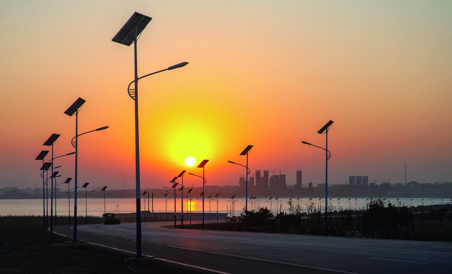 A modern solar-powered street light against a blue sky